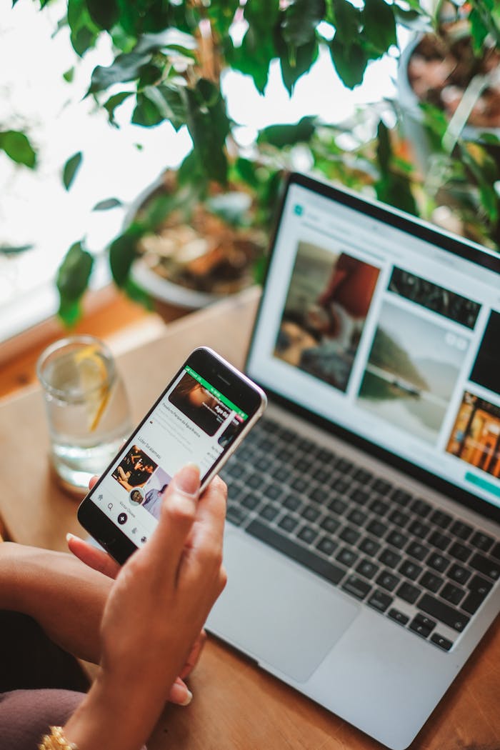 why-choose-us A cozy workspace featuring a smartphone and laptop used for social networking surrounded by greenery.